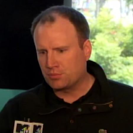 Kevin Feige is wearing a black polo shirt.